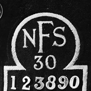 Close up of the breast badge of a National Fire Service uniform. September 1941