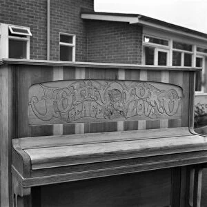 Close up of the carving on the John Lennon piano which says Joan and Yoko, Pease and Love