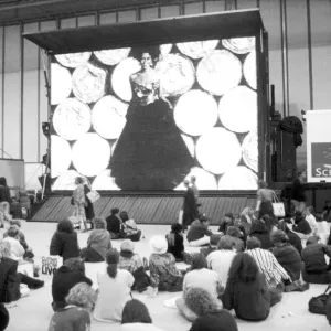 Clothes Show Live, visitors to the clothes show relax beneath one of the giant video Clothes Show Live, visitors to the clothes show relax beneath one of the giant video
