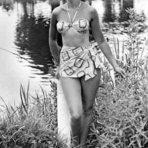 Clothing Beach: Casino Bikini. Swimwear. Swimming costume. Model stands by a lake