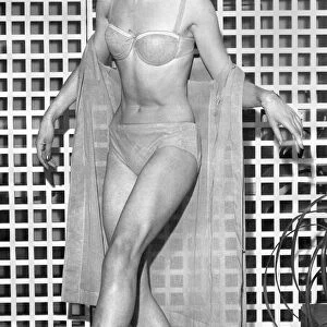 Clothing Beach. Model shows bikini and sheer wrap. March 1963 P017972