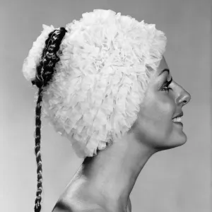 Clothing : Beach. Woman models a frilly swimming hat. October 1970 P017299 Clothing : Beach. Woman models a frilly swimming hat. October 1970 P017299