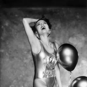 Clothing Beach. Woman models a shiny swimming costume with Happy New Year Clothing Beach. Woman models a shiny swimming costume with Happy New Year