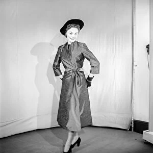 Clothing: Fashion: Coats. Woman wearing full length coat. 1956 B133