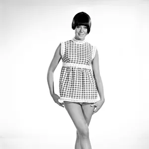 Clothing: Fashion: Dress: Woman wearing gingham dress. 1966 B2008-007