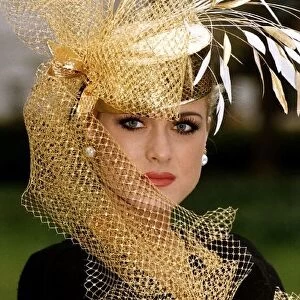 Clothing Fashion Hats by Philip Somerville A gold hat with gold netting modelled