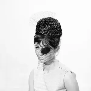 Clothing: Fashion: Hats: Woman wearing hats with veils and eyepatch. 1962 B1544-031