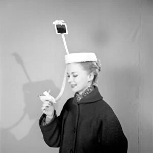 Clothing: Fashion: Hats. Woman wearing periscope hat. 1953 B140