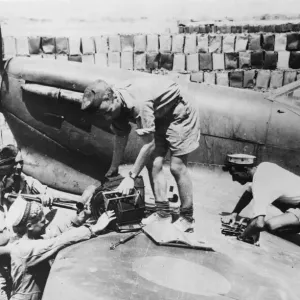 Print of a Spitfire re-arming scene on a Malta aerodrome Print of a Spitfire re-arming scene on a Malta aerodrome
