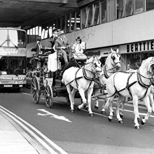 A coach and horse team driving through Newcastle city centre to advertise a new Clipper