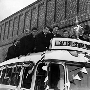 As the coach stops outside the Town Hall at Wigan, the crowd gives a mighty cheer