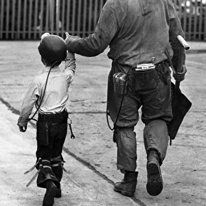 A coal miner walking his son, a junior miner. October 1978 P017740