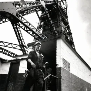 Coal - Miners - General mining shot showing a miner with the winding gear in Coal - Miners - General mining shot showing a miner with the winding gear in