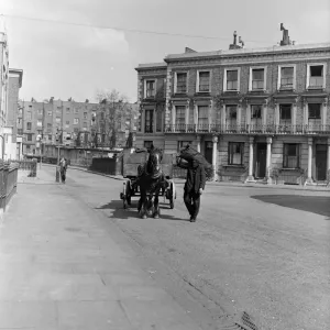 Coalman Mr Nightingale delivering coal. 25th April 1955