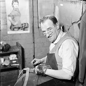 A cobbler at the Mansfield shoe factory in Northampton, hand stitching a pair of shoes