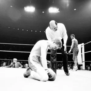 Colin Jones of Wales on the floor after a low punch in the 8th round of his defence of Colin Jones of Wales on the floor after a low punch in the 8th round of his defence of