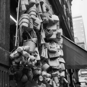 A collection of wicker bags and baskets for sale in Rupert Street, Soho. Circa 1955 A collection of wicker bags and baskets for sale in Rupert Street, Soho. Circa 1955