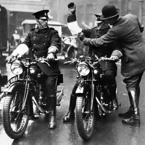 Colonel Laurie adjusting the white armlet of one of the 500 Metropolitan policemen who