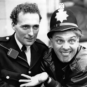 Comedian and actor Rik Mayall pictured with PC David Jones