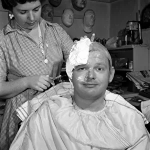 Comedian Benny Hill having a plaster cast of his skull made, so a wig can be made