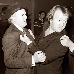 Comedian Mel Smith in a scuffle with stars of the television series Minder George Cole