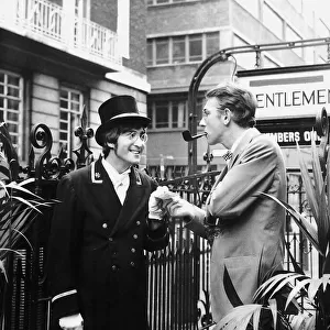 Comedian Peter Cook stands in Carnaby Steet during the filming of sketch for