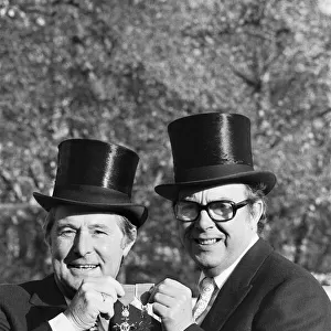 Comedians Morecambe and Wise seen here showing off their medals outside Buckingham Palace