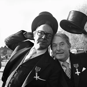 Comedians Morecambe and Wise seen here showing off their medals outside Buckingham Palace