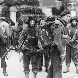 Commandos pause during cleaning up of village during WWII. Circa 1940s Commandos pause during cleaning up of village during WWII. Circa 1940s