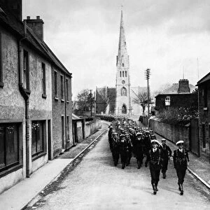 Two companys of men from HMS Rodney march through Invergordon Scotland after docking at