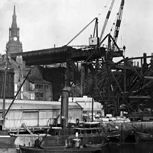 Construction of the new Tyne Bridge. The Tyne Bridge is a through arch bridge over
