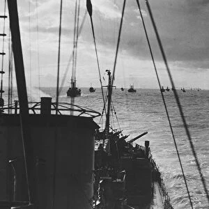 Convoy of ships with a destroyer escort crosses the Atlantic during WW2 1943