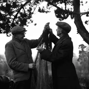 Coracle Fisherman sorting out their fishing nets 1952