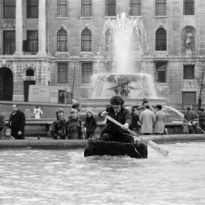 Coracle fishermen in London. One of the fishermen paddles his coracle round Trafalgar Coracle fishermen in London. One of the fishermen paddles his coracle round Trafalgar