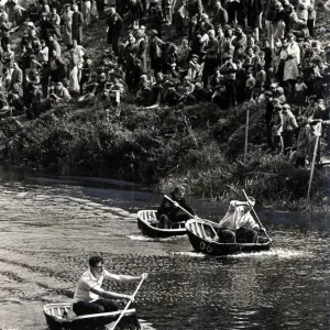 Coracle Racing - Tense moment during a coracle race as crowds line the banks of the River