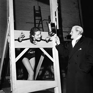 Count Dominic tries out his guillotine on Marion Dorie while Penny Kay
