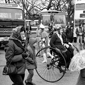 A couple ride their victorian tandam tricycle in the Easter parade, Battersea Park