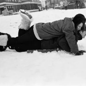 A couple sledging in Greenwich Park, London Print 1970 A couple sledging in Greenwich Park, London Print 1970