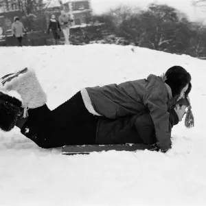 A couple sledging in Greenwich Park, London, 27th December 1970 A couple sledging in Greenwich Park, London, 27th December 1970