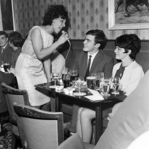 A couple get the treatment from a singer in Dundee Lounge Bar. 6th June 1967 A couple get the treatment from a singer in Dundee Lounge Bar. 6th June 1967