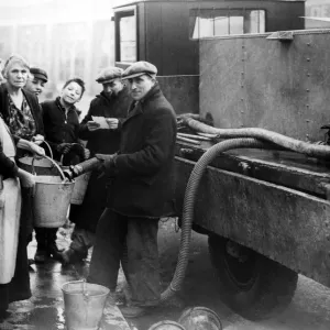 Coventry Corporation workers taking water round to residents that have been bombed