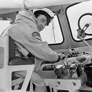 Coxswain Mr. Frank Tinsley seated at the controls of the Barry lifeboat during an