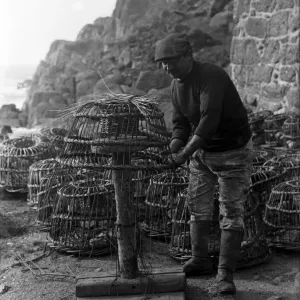 Crabpot making at Penberth, Shaping a crab pot. Cornwall. 1923 Crabpot making at Penberth, Shaping a crab pot. Cornwall. 1923