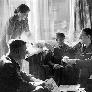 Crew and officers of the RAF enjoying a cup of tea from their host in Blackpool during