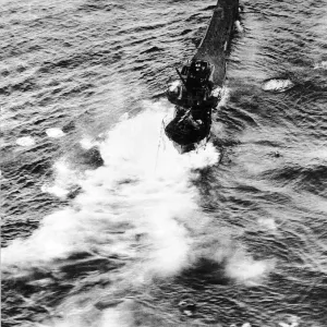 The crew of a sinking German U Boat scramble into the lifeboats after being hit by a The crew of a sinking German U Boat scramble into the lifeboats after being hit by a