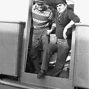 Crewman of the trawler Magritte seen here having a cigarette whilst tied up at St Andrews
