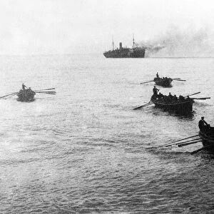 Crews of sunken German ships being rowed to a waiting English war vessel after coming