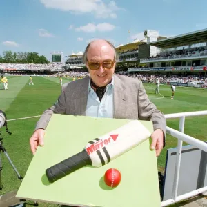 Cricket commentator Henry Blofeld is presented with a Daily Mirror cake in the shape of a