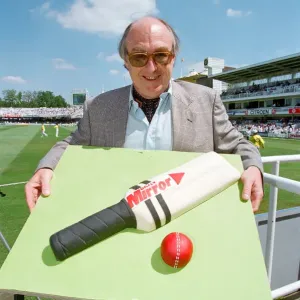 Cricket commentator Henry Blofeld is presented with a Daily Mirror cake in the shape of a