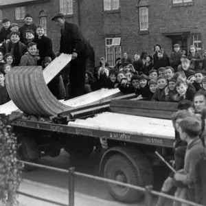 A crowd of excited yougsters watch the delivery of the first consignment of A. R. P A crowd of excited yougsters watch the delivery of the first consignment of A. R. P
